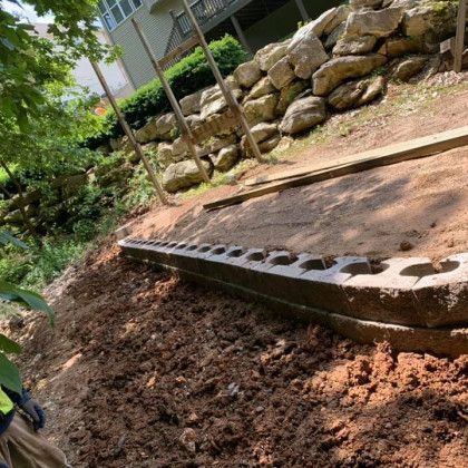 A row of concrete blocks sitting on top of a pile of dirt.