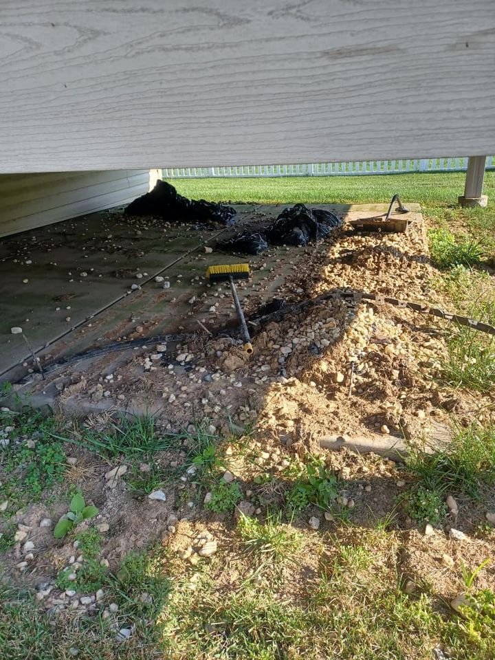A wooden deck is being built under a house.