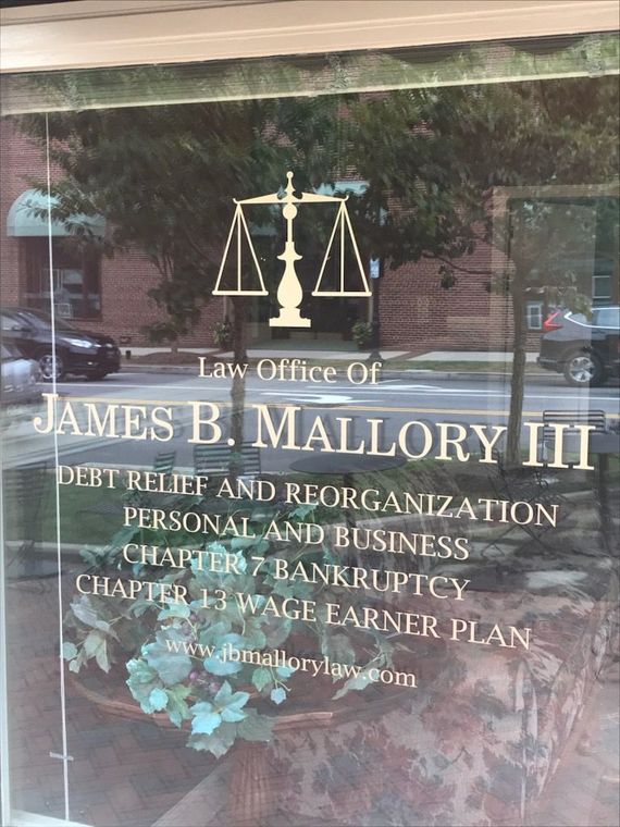 Law office storefront with a scale symbol and text, 