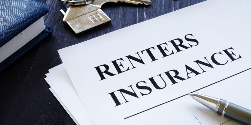 A pen is sitting on top of a piece of paper that says renter 's insurance.