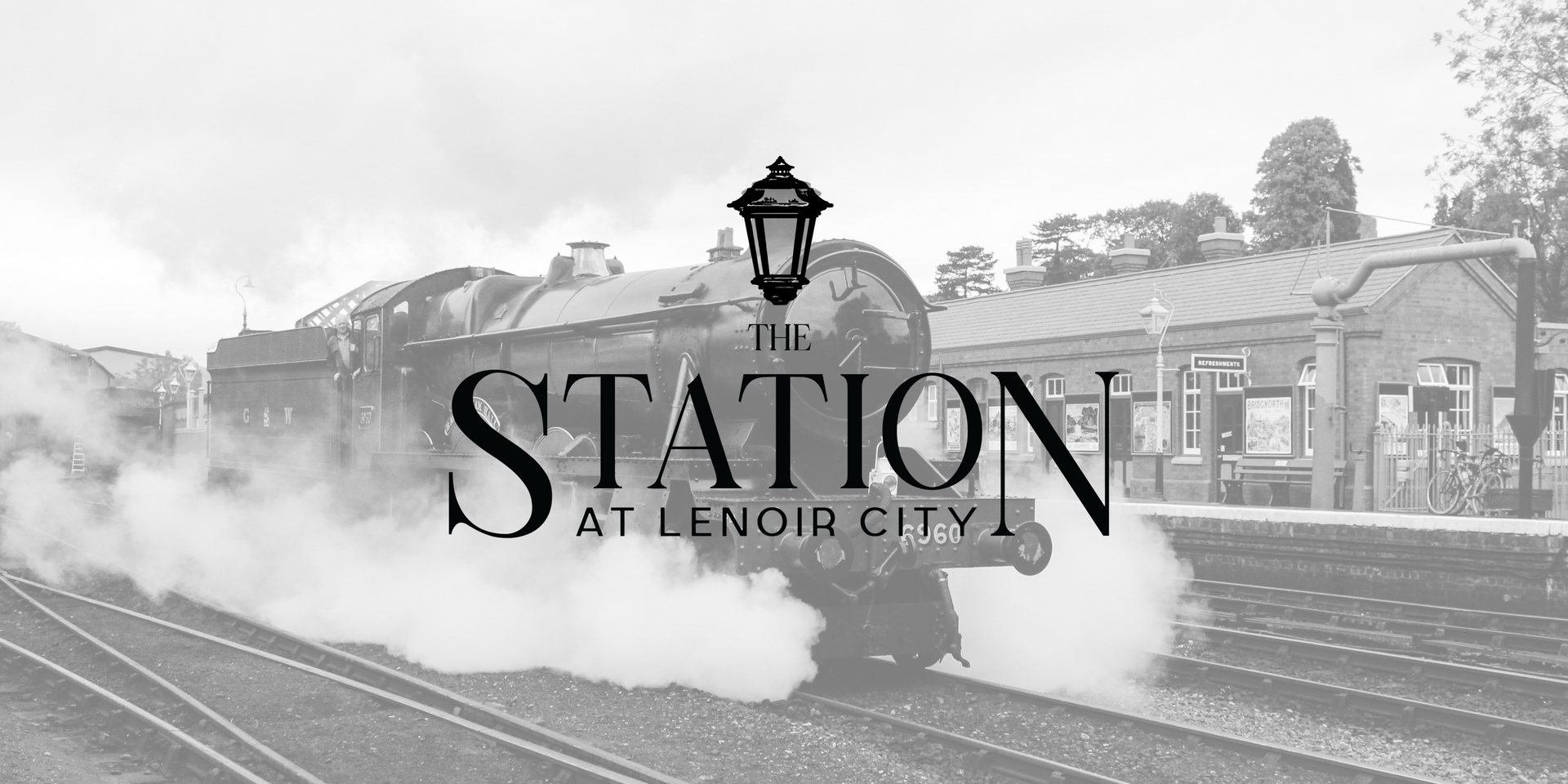 A black and white photo of a train that says the station at lenoir city