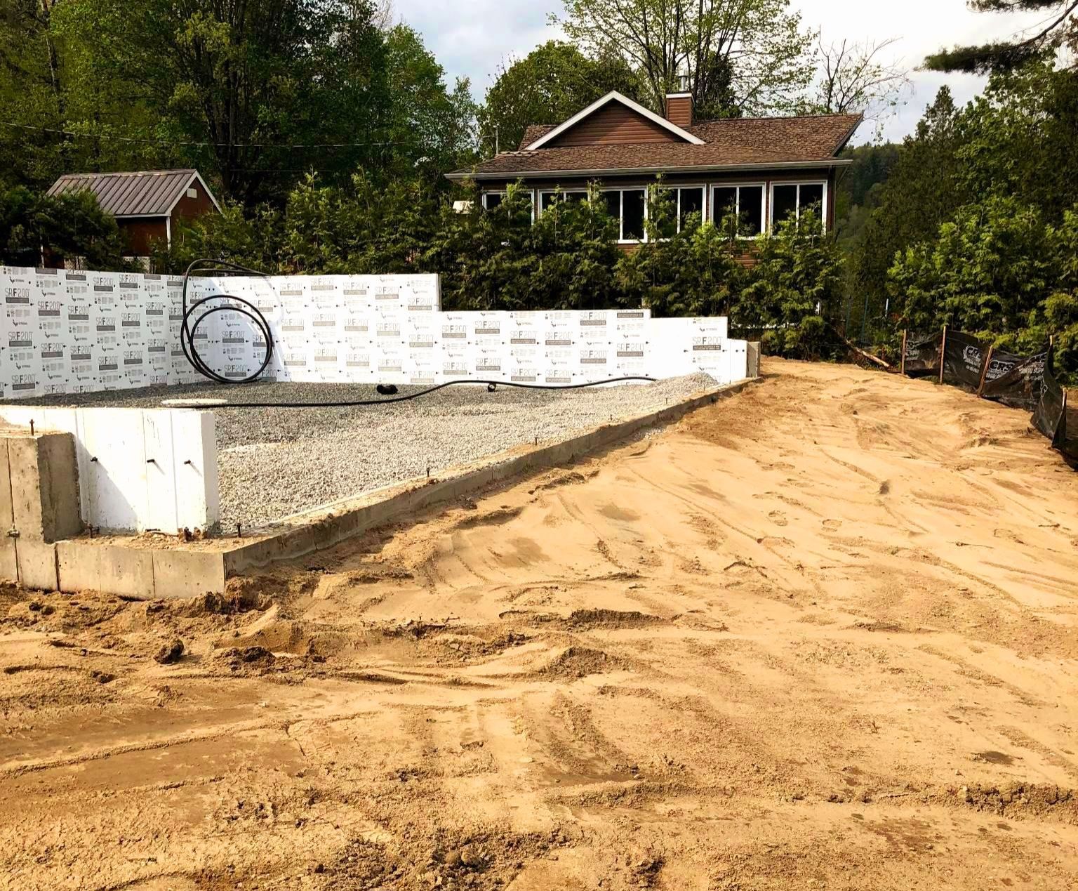 Un chemin de terre menant à une maison dans les bois.