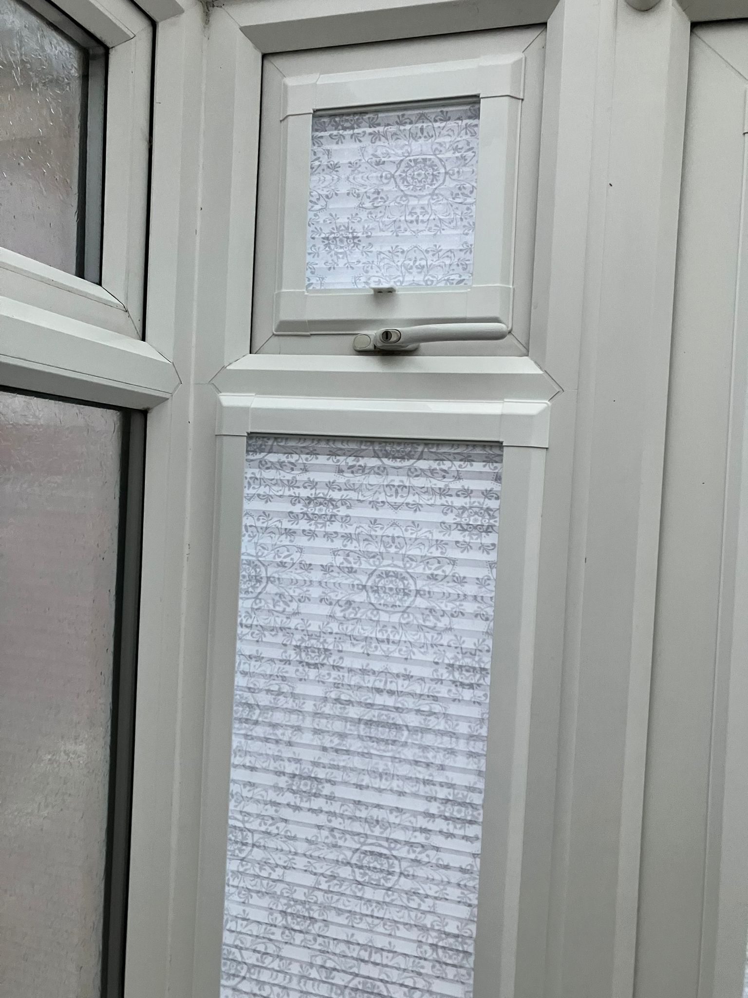 A close up of a window with a blind on it.