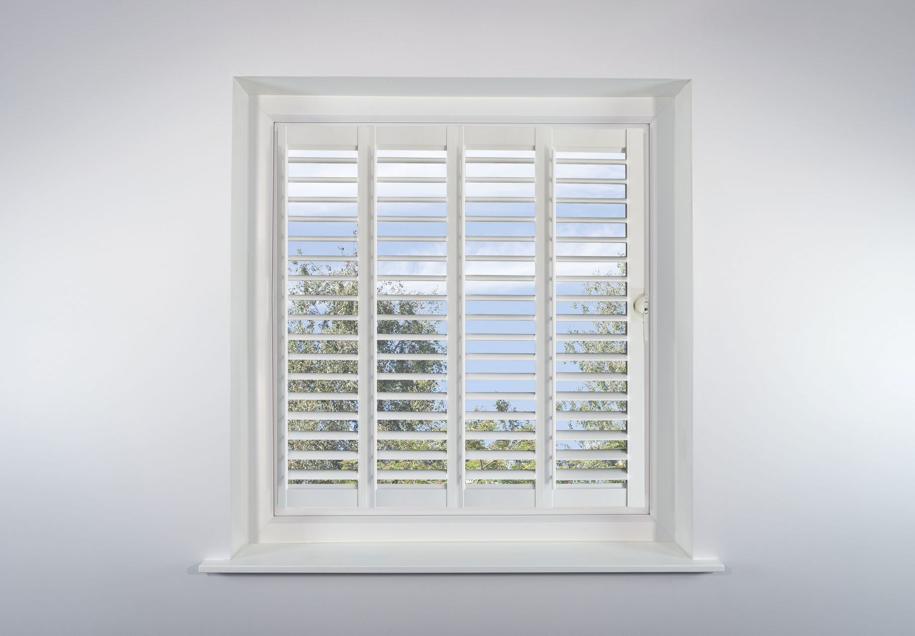 A white window with white shutters on it