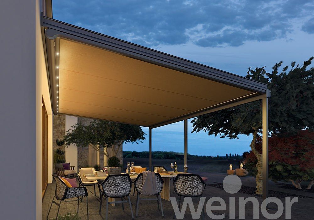 A patio with tables and chairs under a canopy.