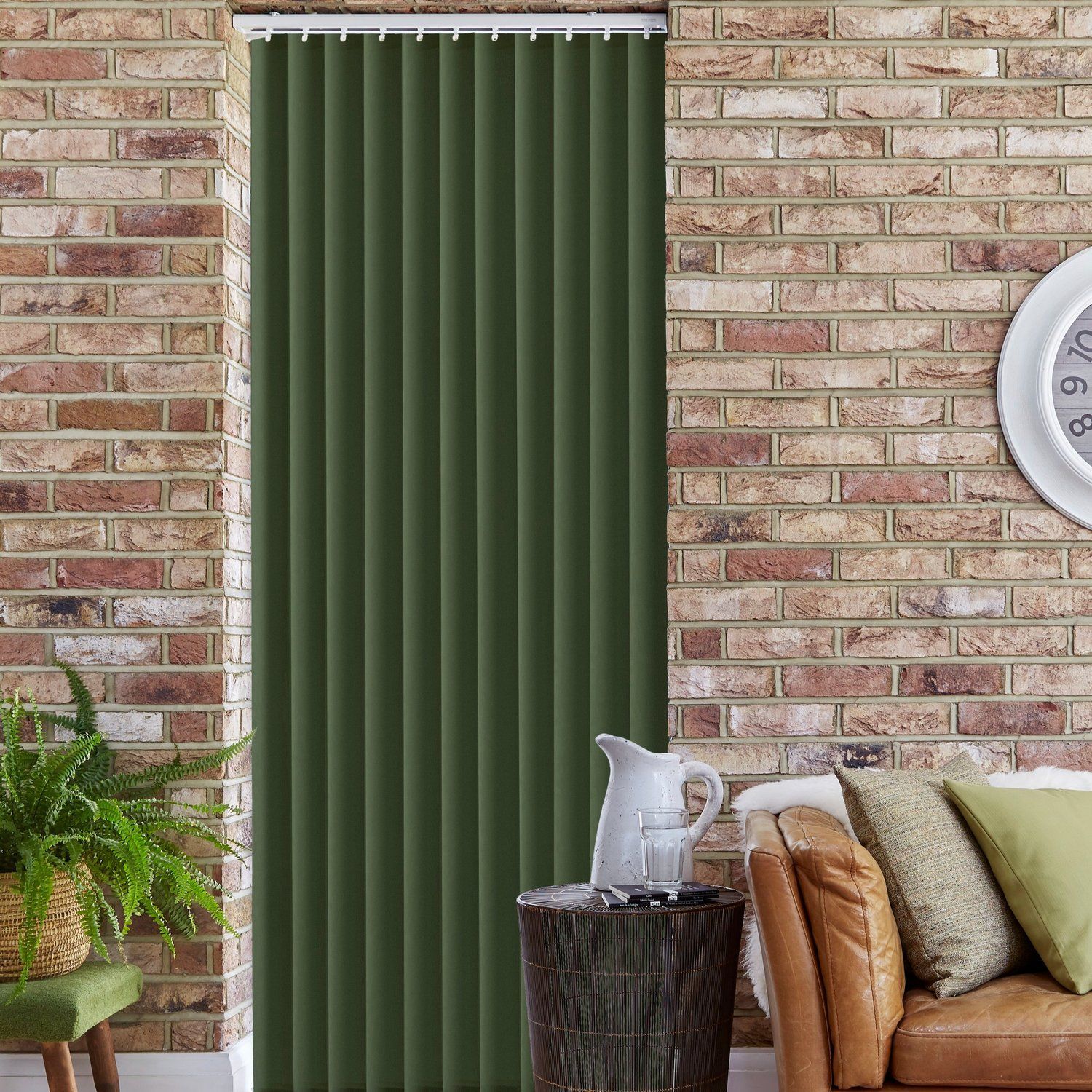 A living room with a couch , table , clock and green blinds.