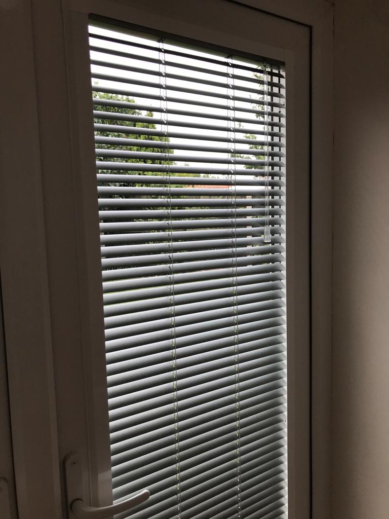 A close up of a window with blinds on it.