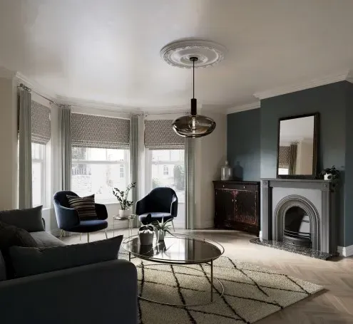 A living room with a fireplace , couch , chairs , coffee table and mirror.