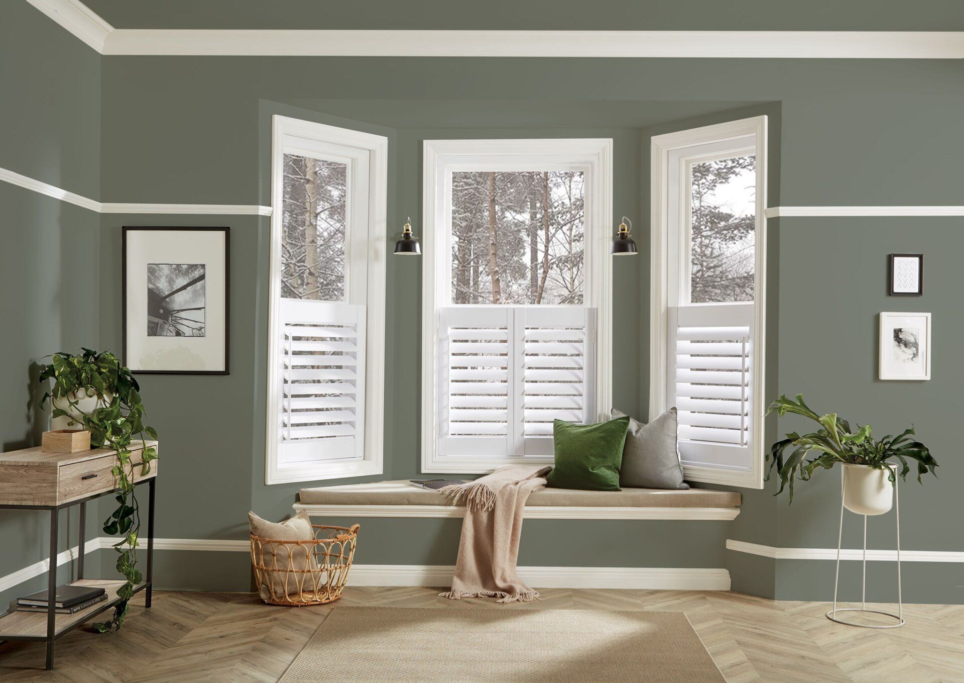 A living room with a window seat and shutters on the windows.