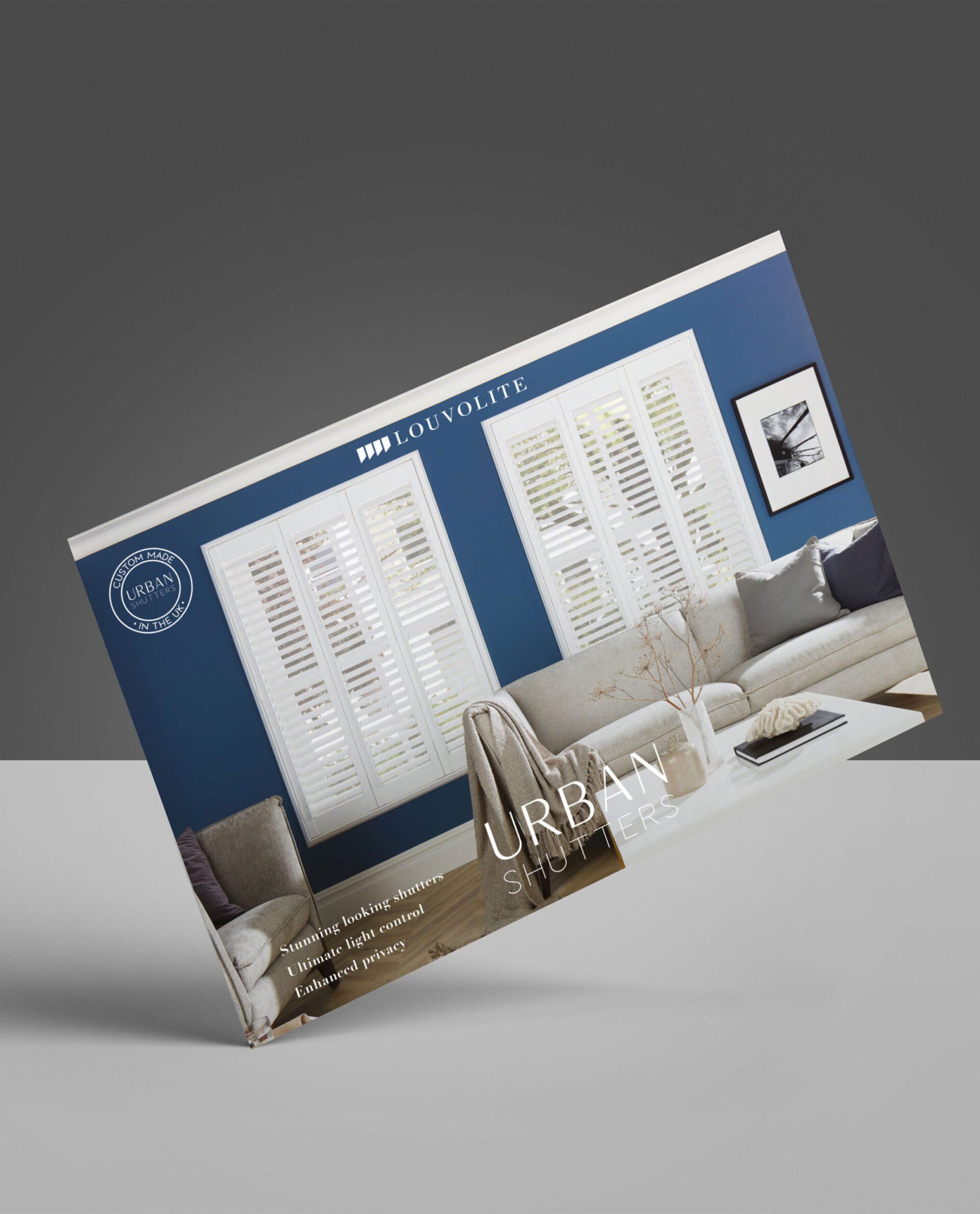 A business card with a picture of a living room on it is sitting on a table.