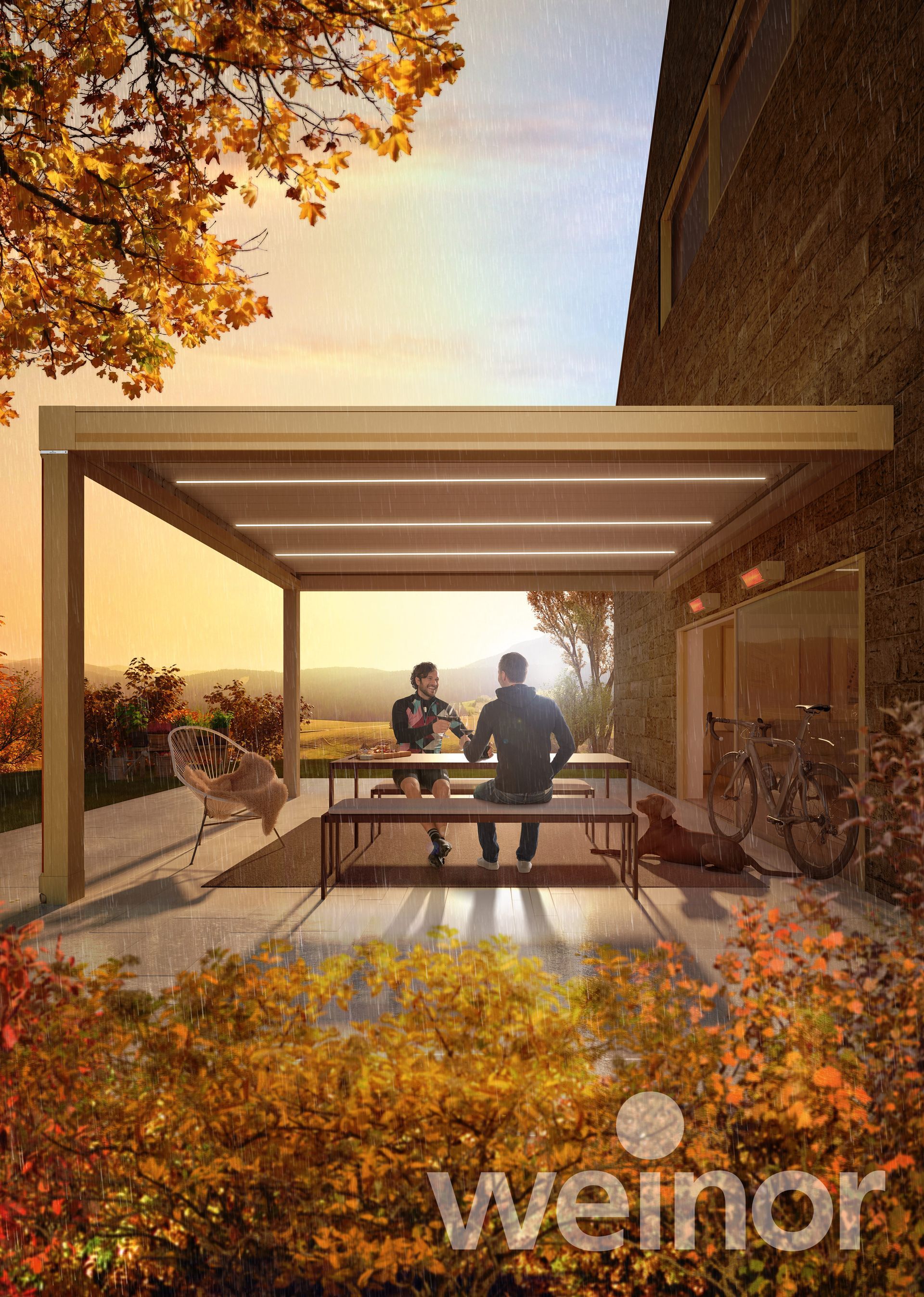 A man and woman are sitting at a table under a pergola.