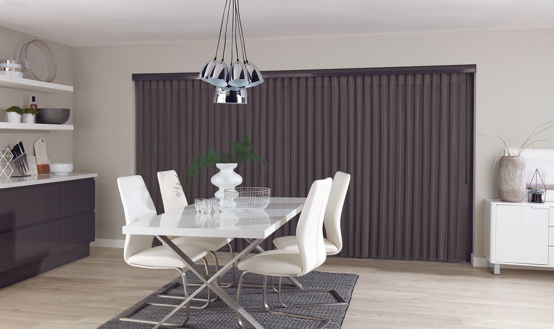 A dining room with a table and chairs and a chandelier.