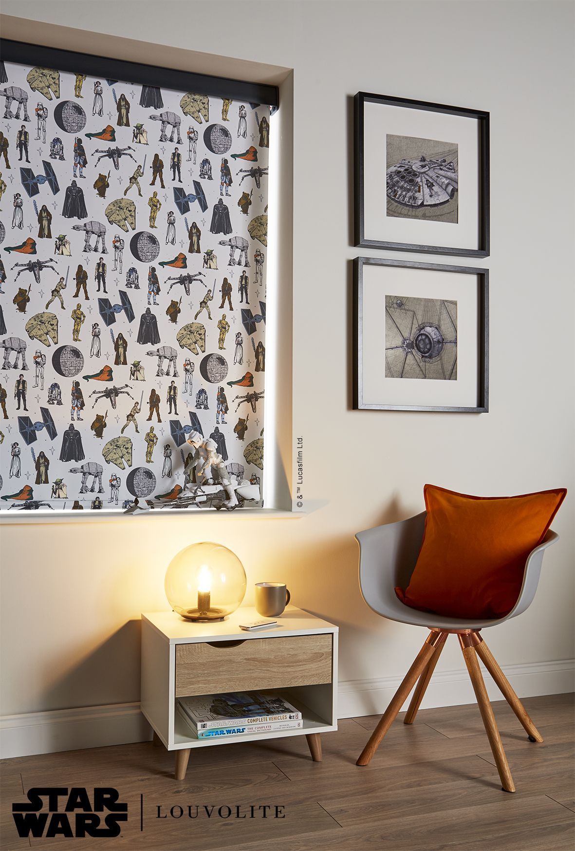 A room with a chair , nightstand , lamp and star wars wallpaper on the wall.