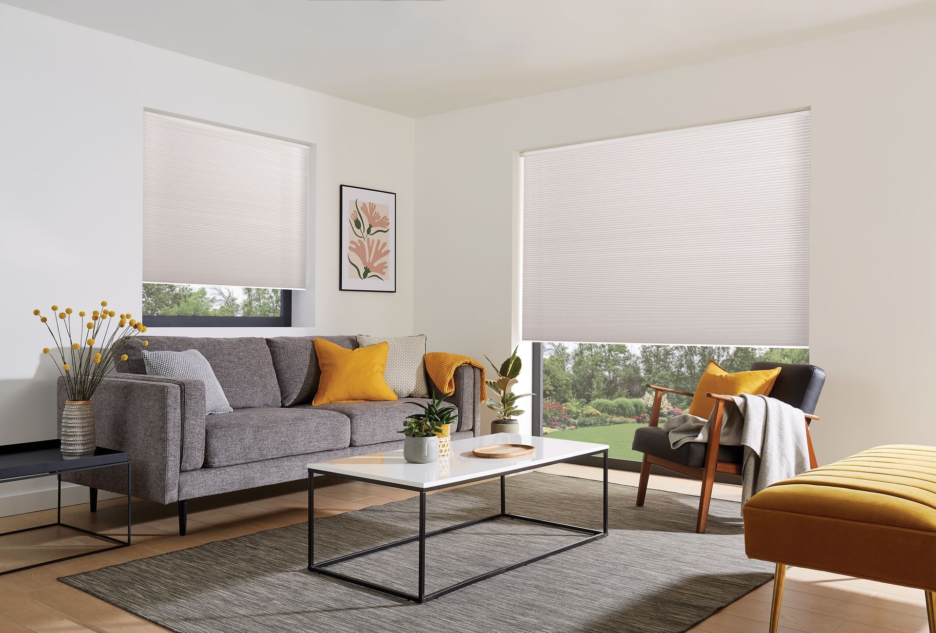 A living room with a couch , chair , coffee table and window.