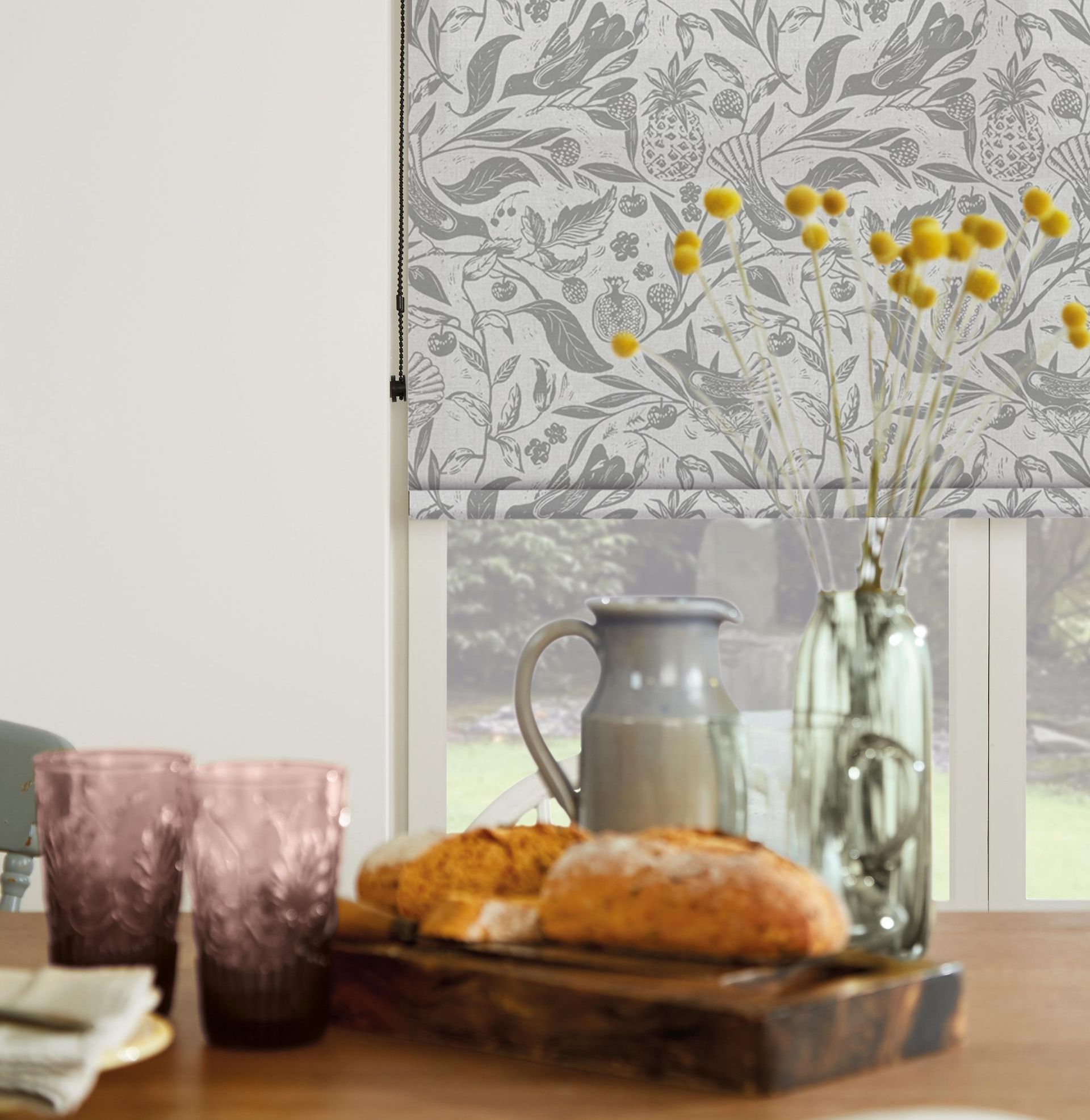 A dining room table with a tray of food and glasses