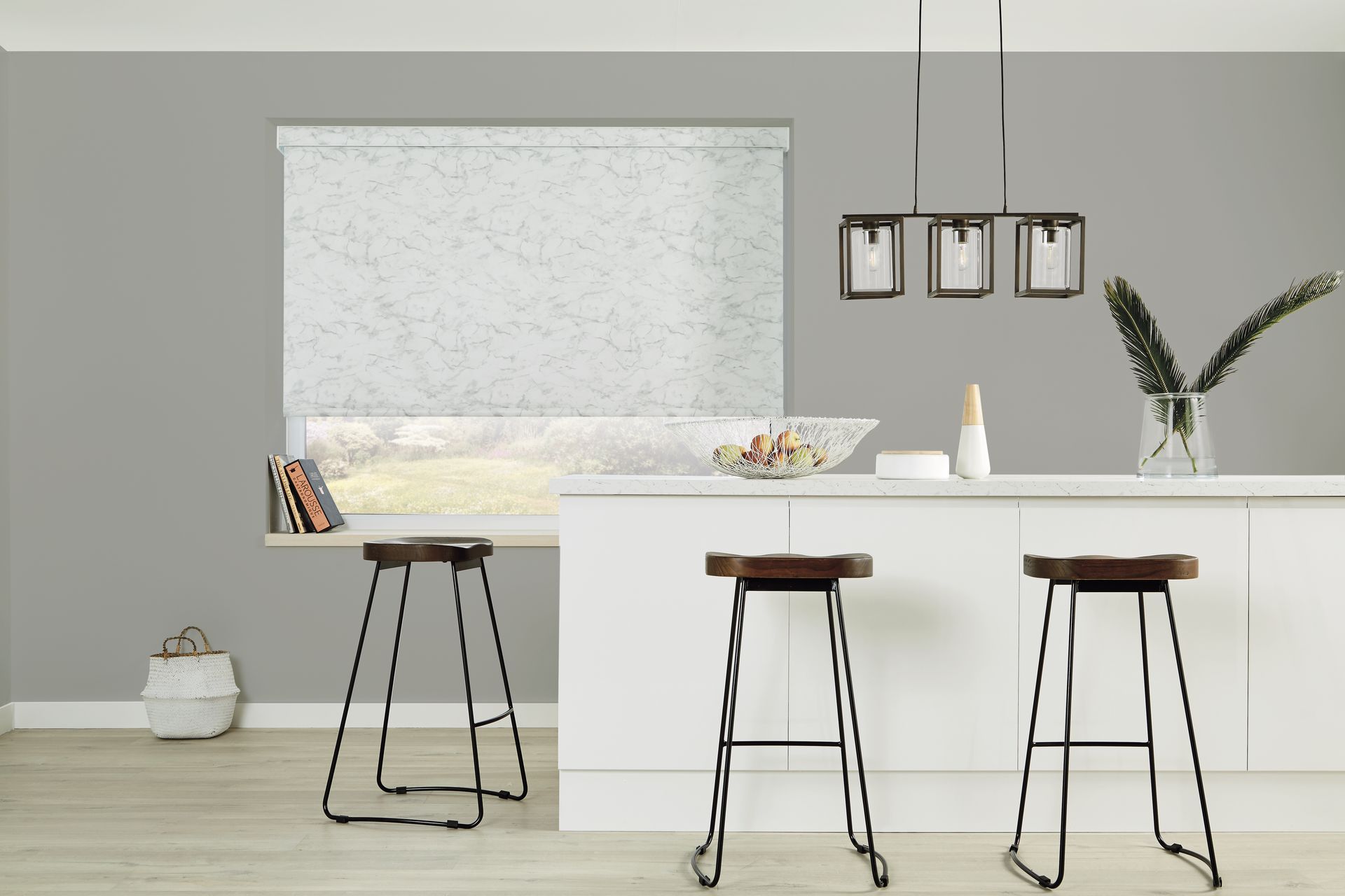 A kitchen with two bar stools and a window with a blind on it.