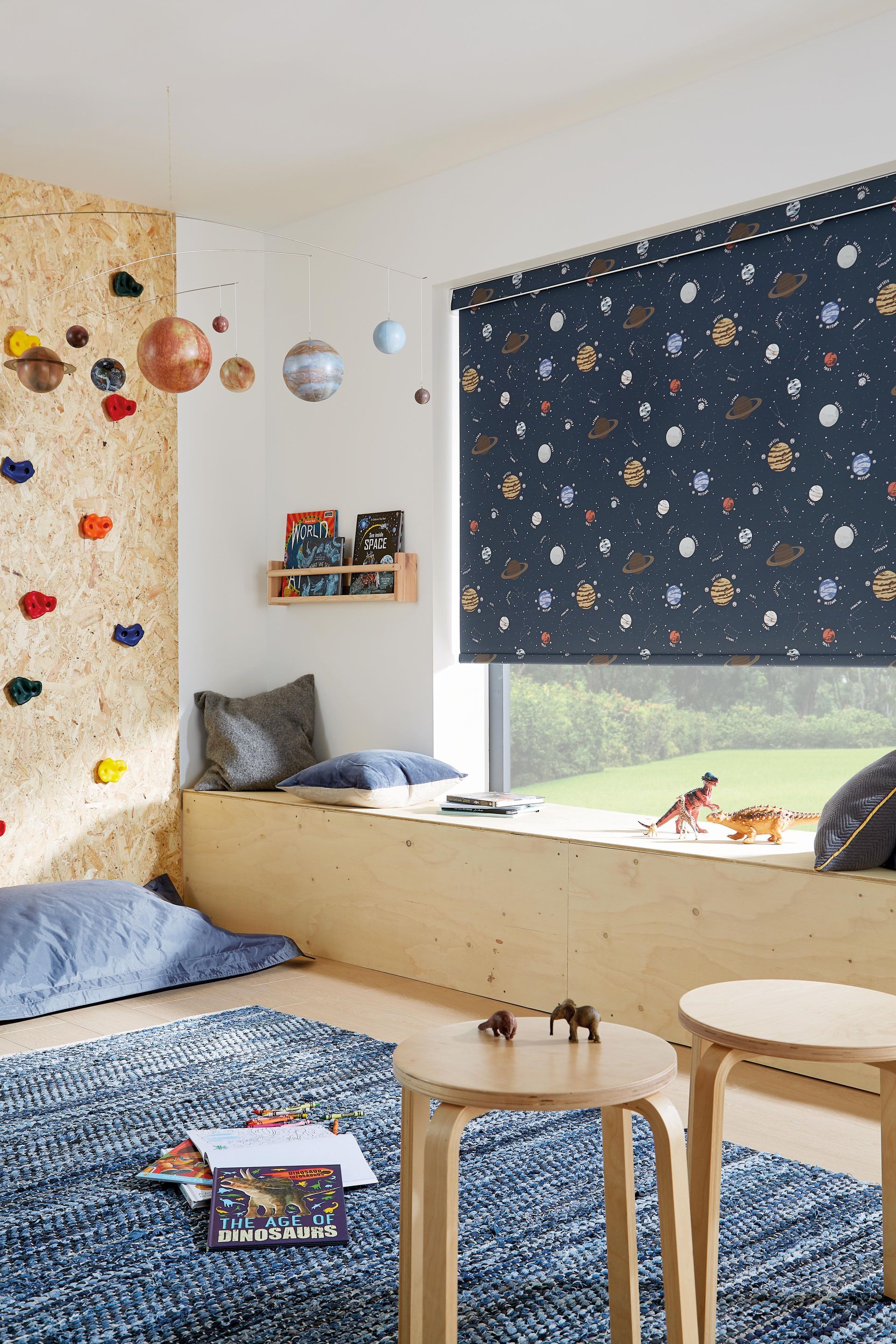 A child 's room with a climbing wall and a window seat.