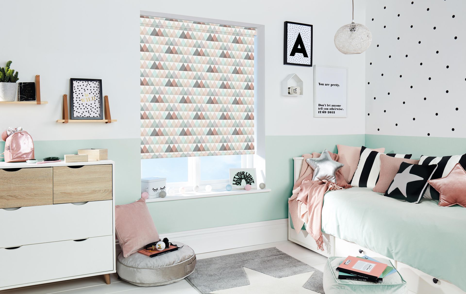 A bedroom with a bed , dresser , and window.