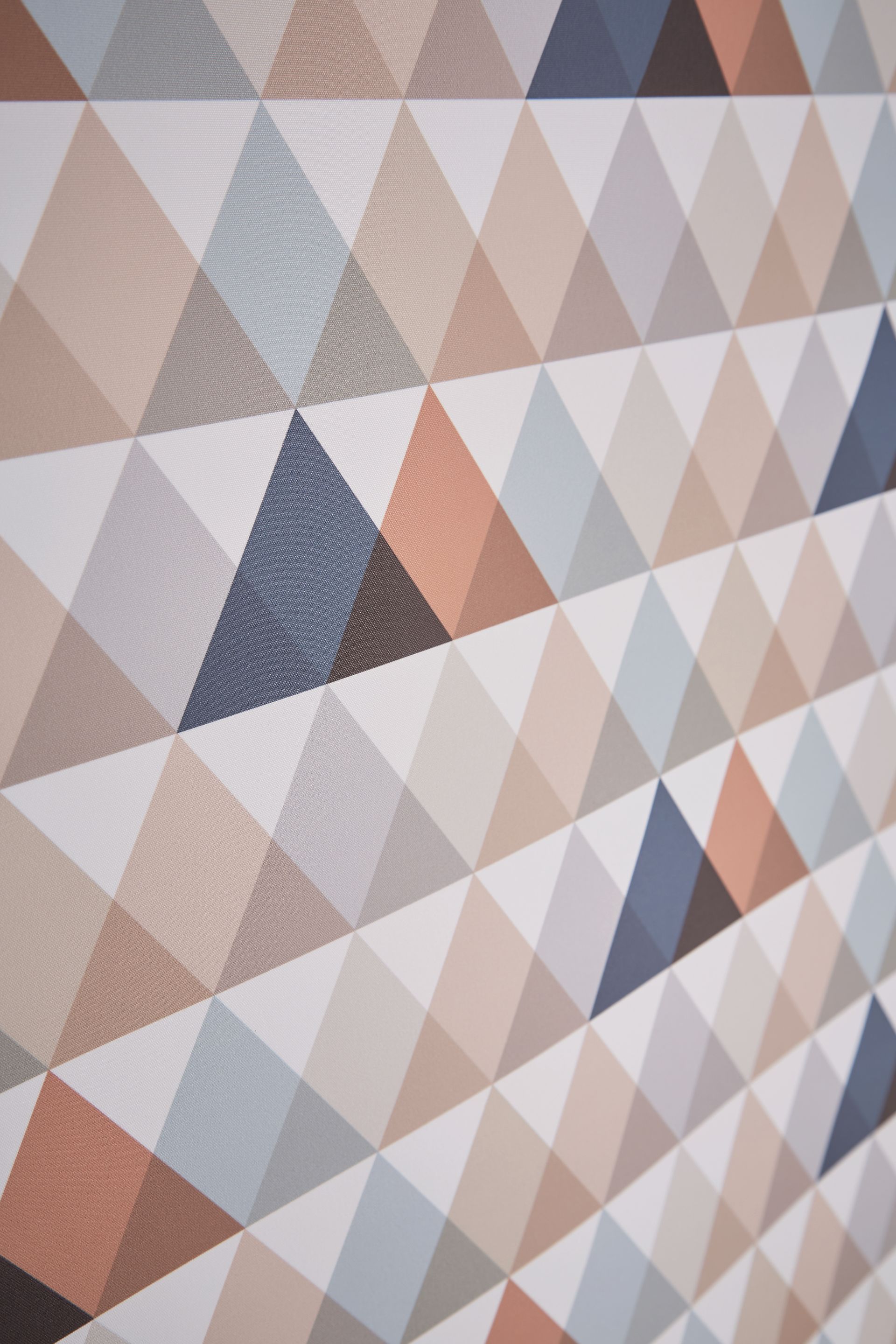 A close up of a colorful geometric pattern on a wall.