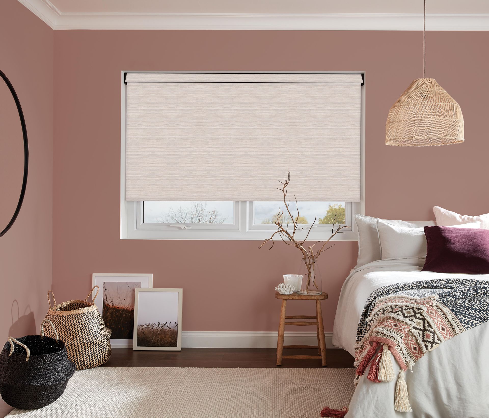 A bedroom with pink walls and a white bed