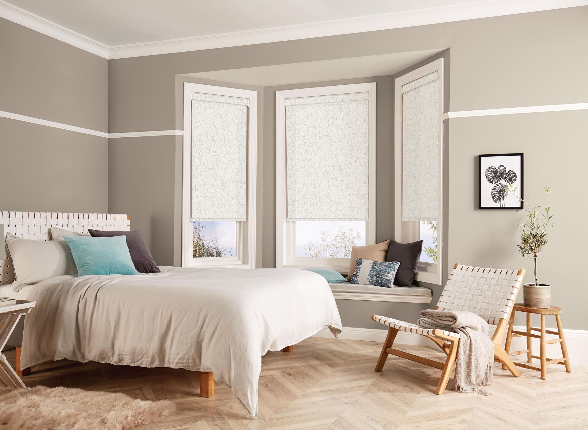 A bedroom with a bed , chair and window seat.