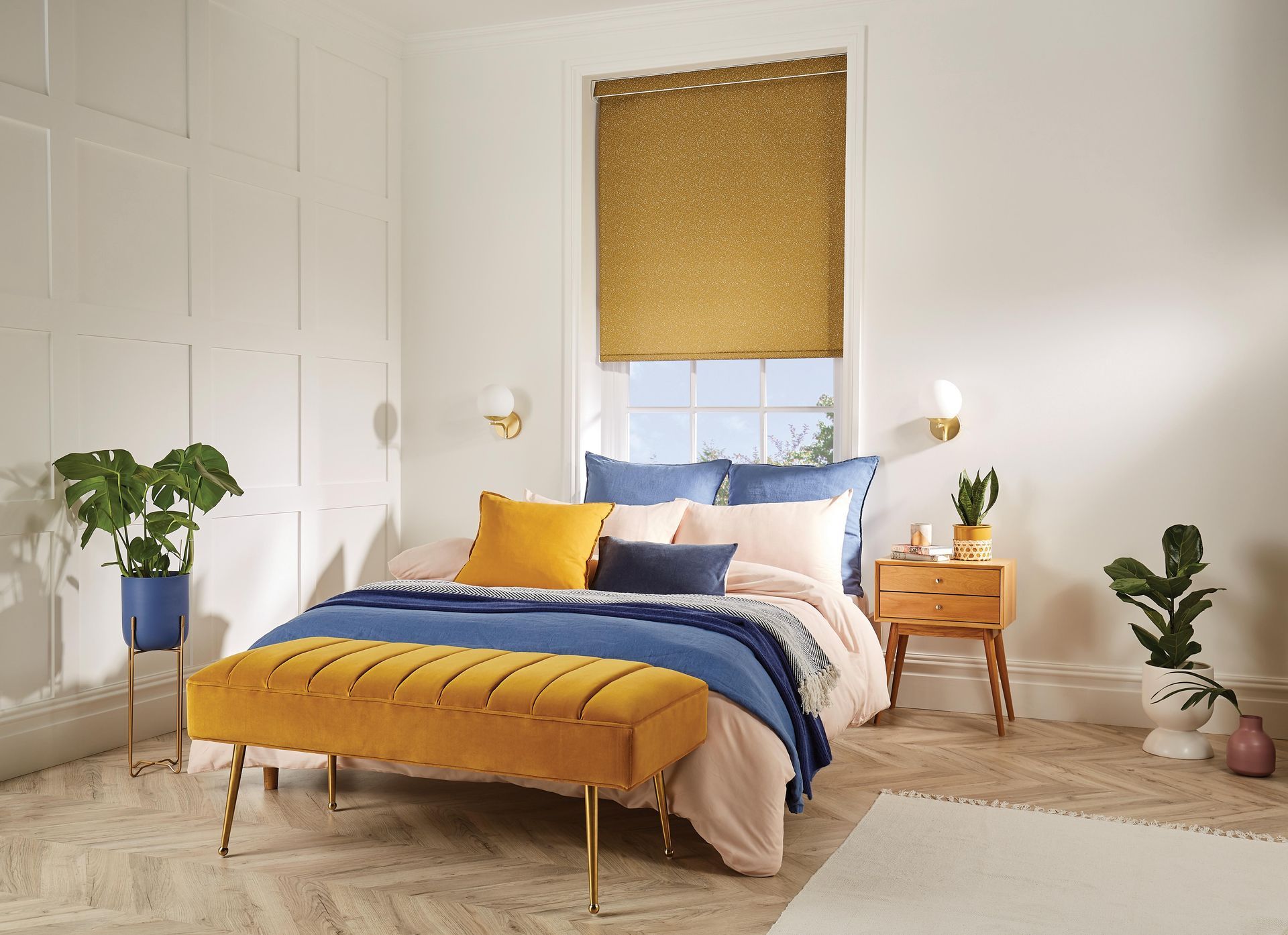 A bedroom with a bed , bench , nightstand , and window.