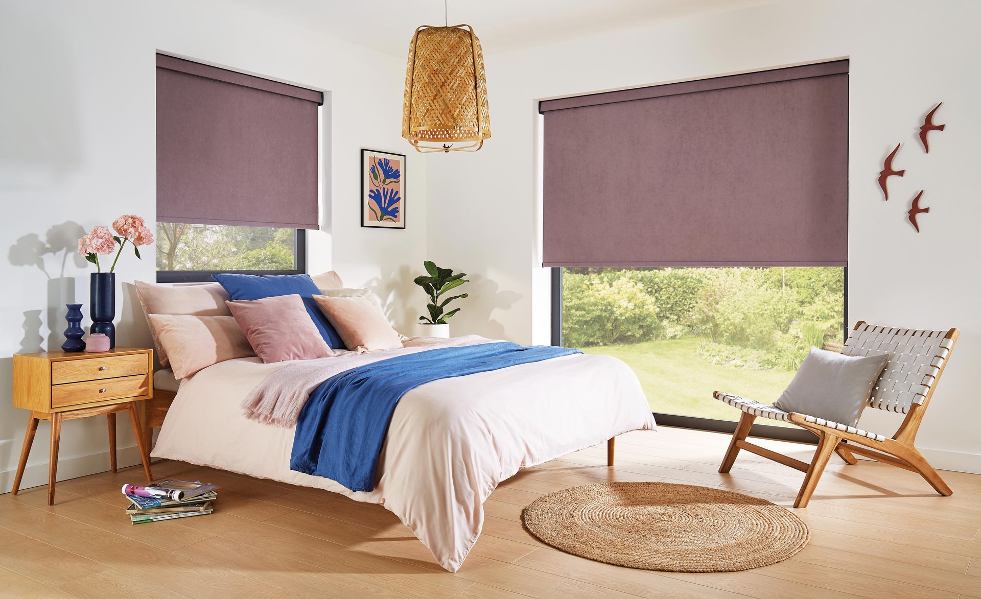 A bedroom with a bed , chair , nightstand and purple blinds.