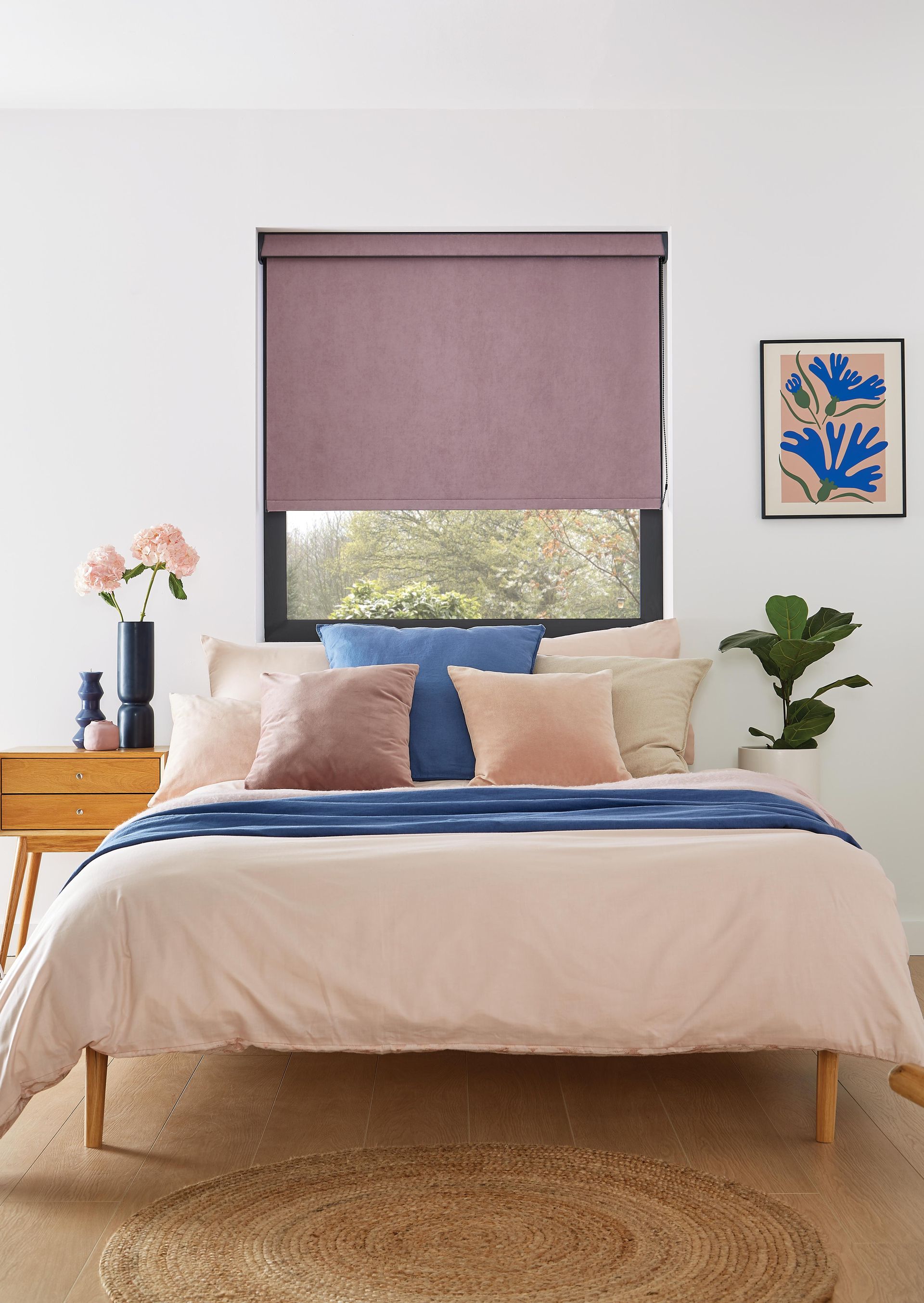 A bedroom with a bed and a window with a purple blind.