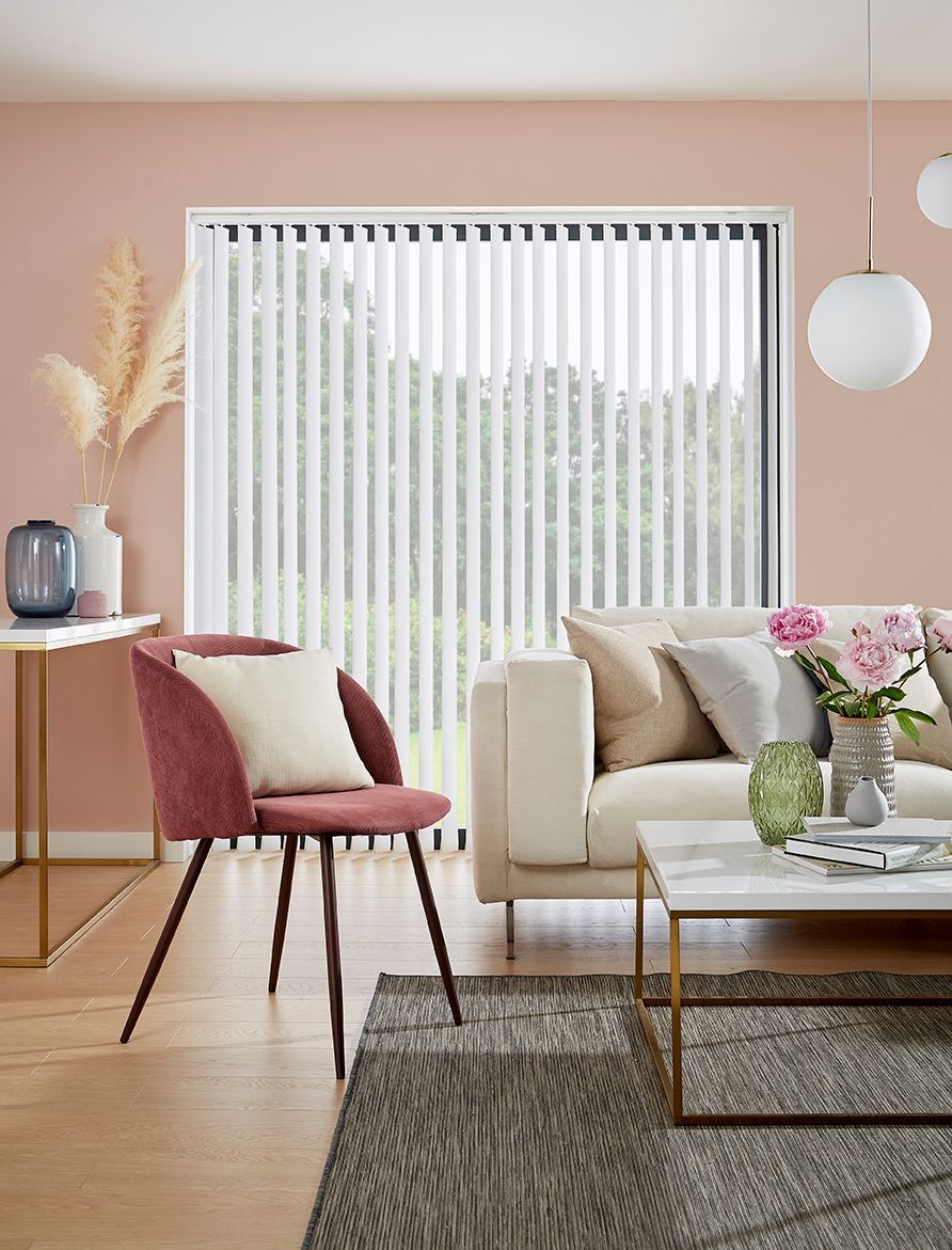 A living room with a couch , chair , coffee table and blinds.