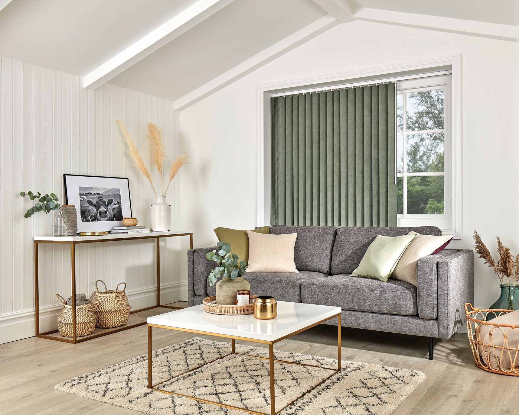A living room with a couch , coffee table , and blinds.
