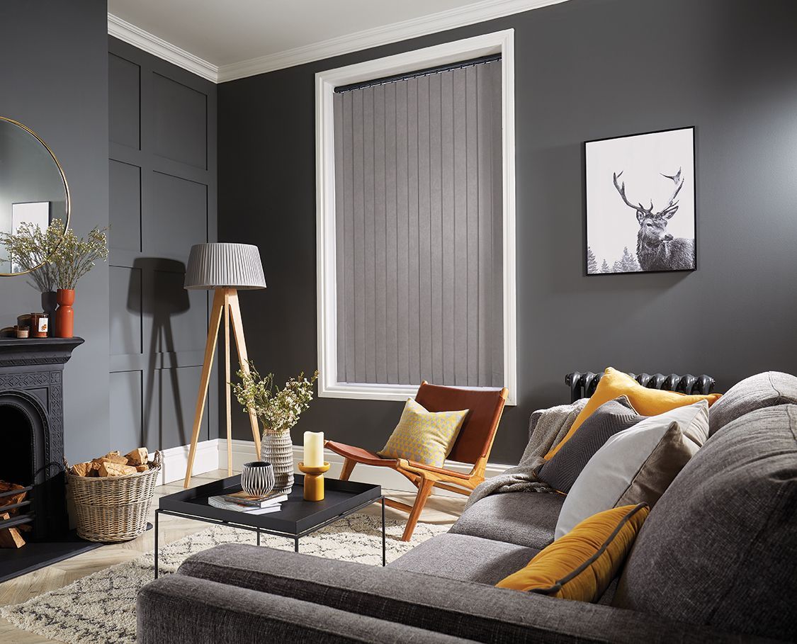 A living room with a couch , chair , table and fireplace.