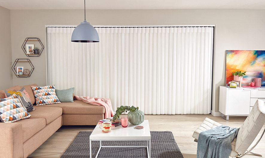 A living room with a couch , chair , coffee table and television.