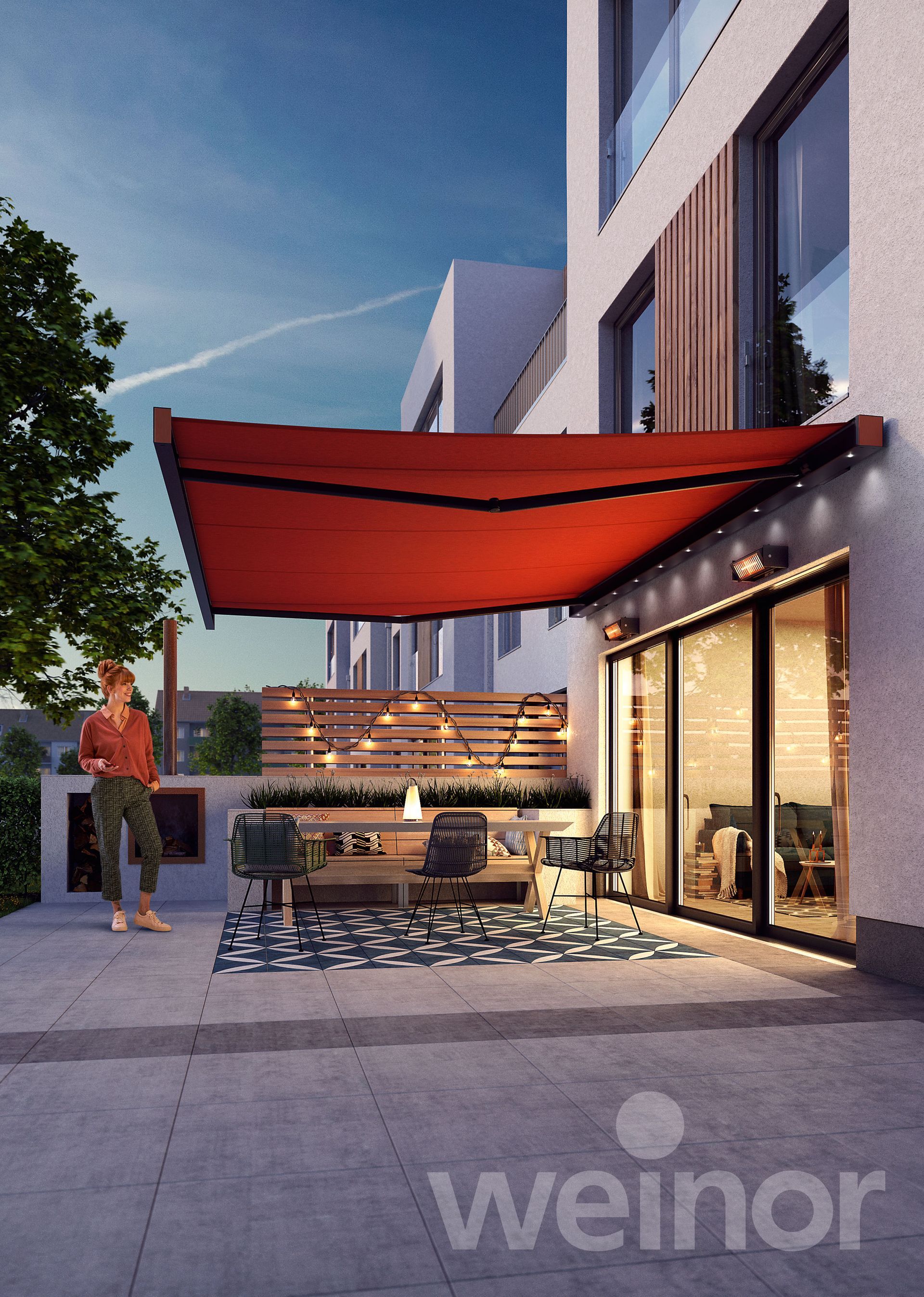 A man is standing under a red awning in front of a weinor building
