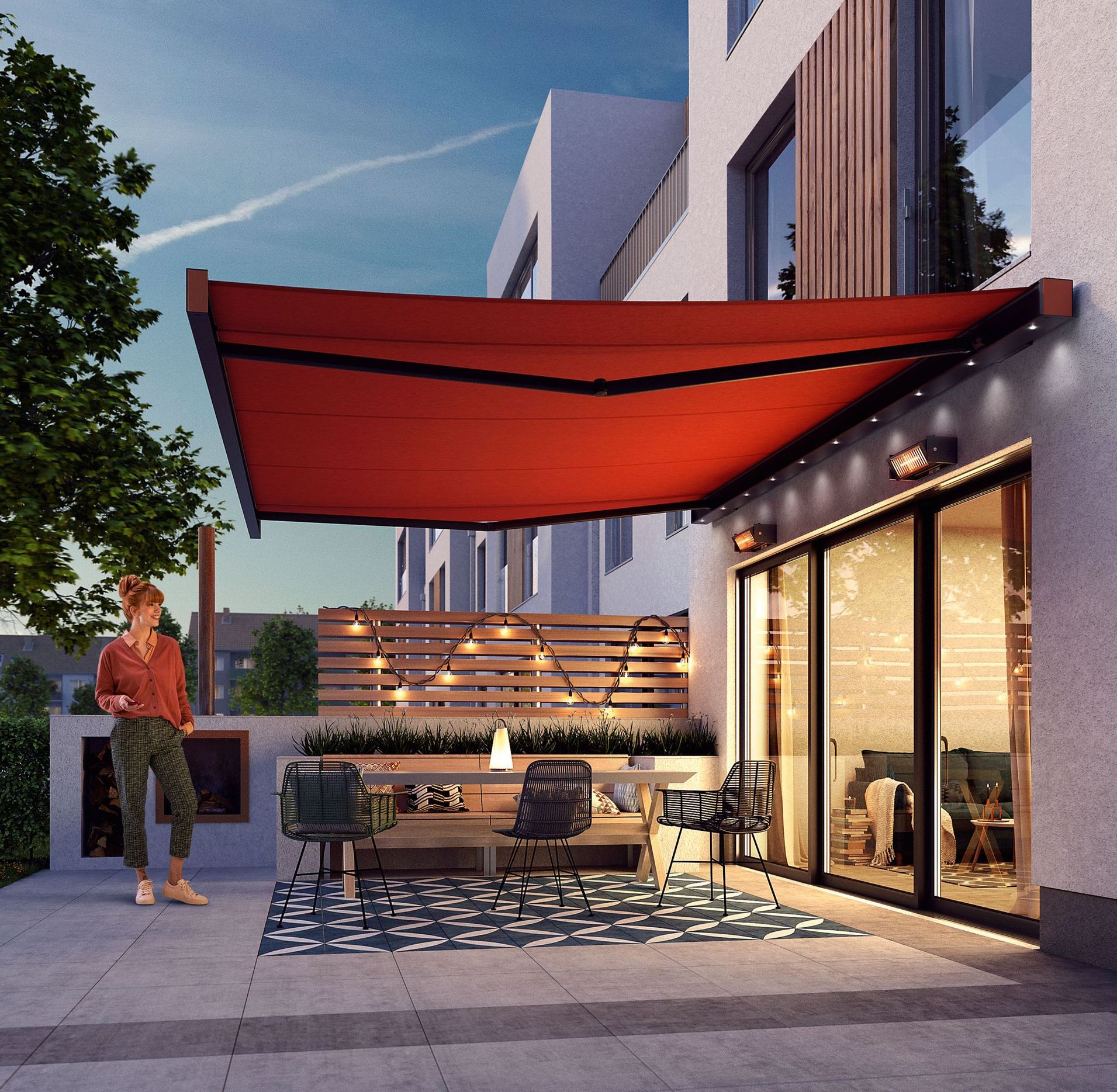 A woman is standing under a red awning on a patio