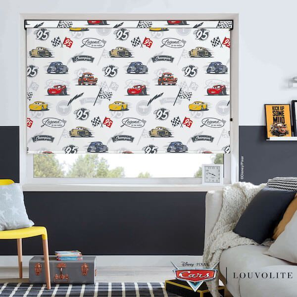 A living room with a couch and chair and a window with cars on it