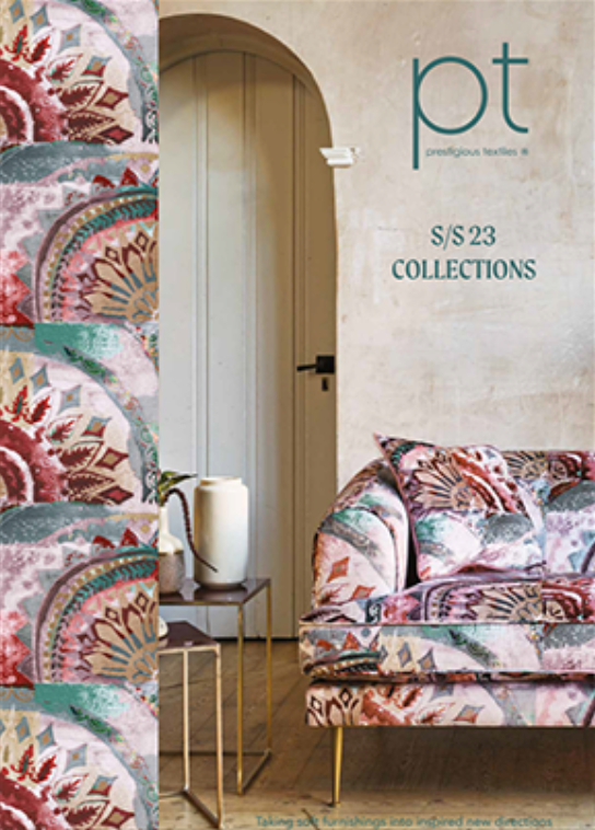 A living room with a couch and a table with the word collections on it