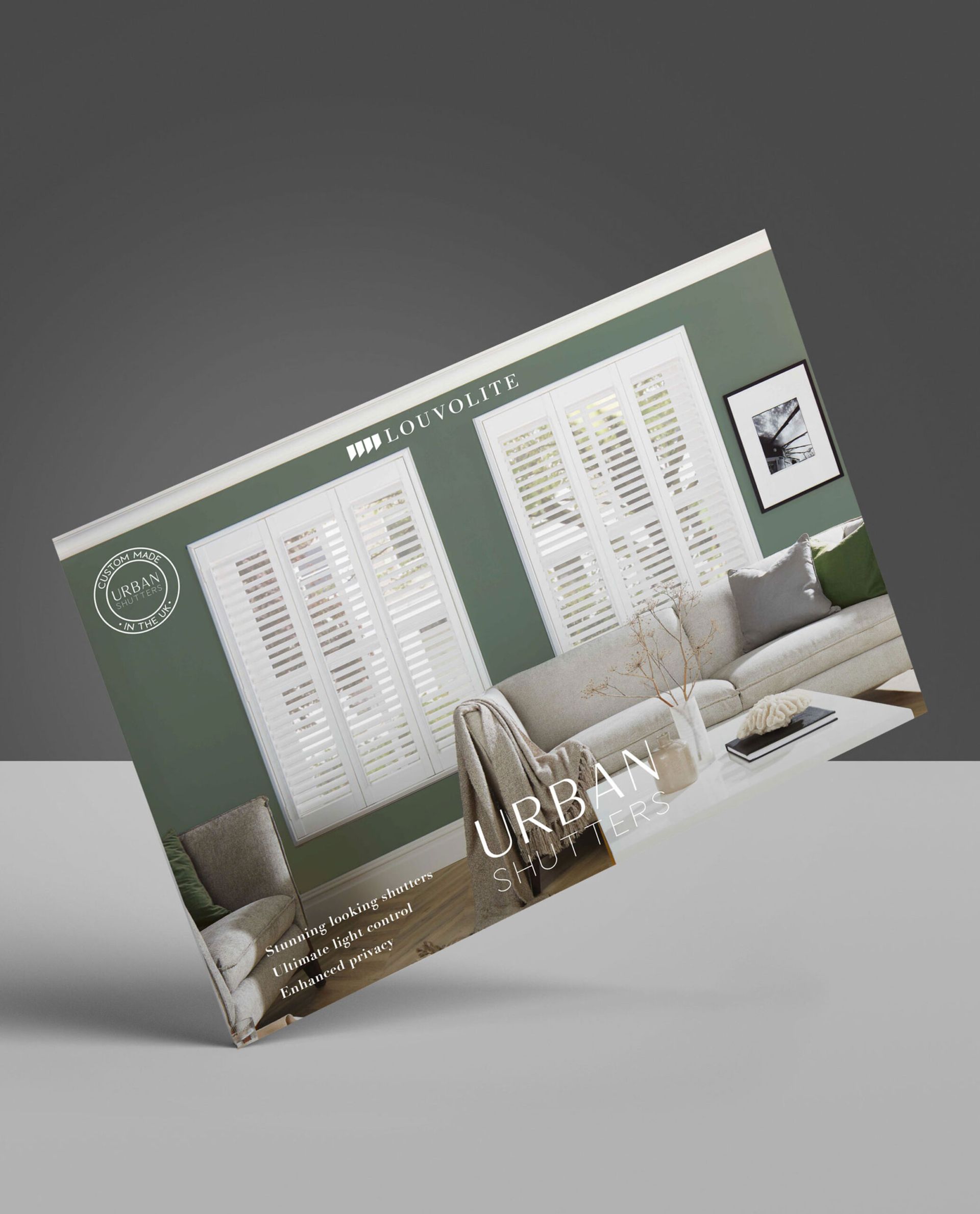 A business card with a picture of a living room on it is sitting on a table.