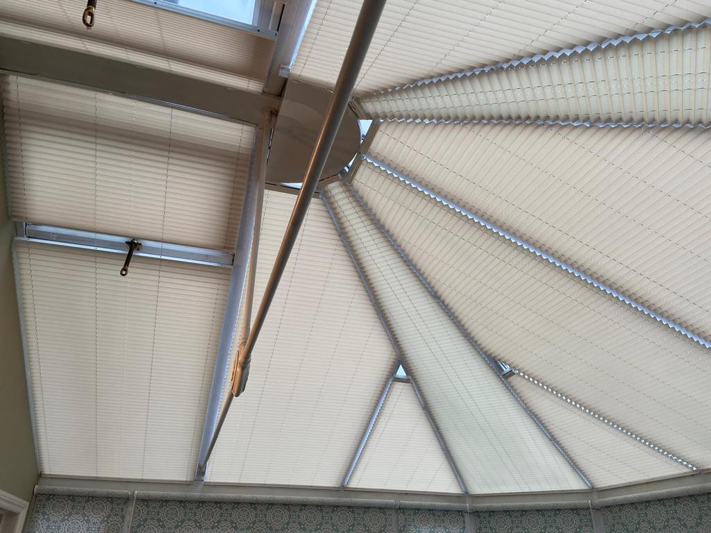 Looking up at the ceiling of a building with a white awning.