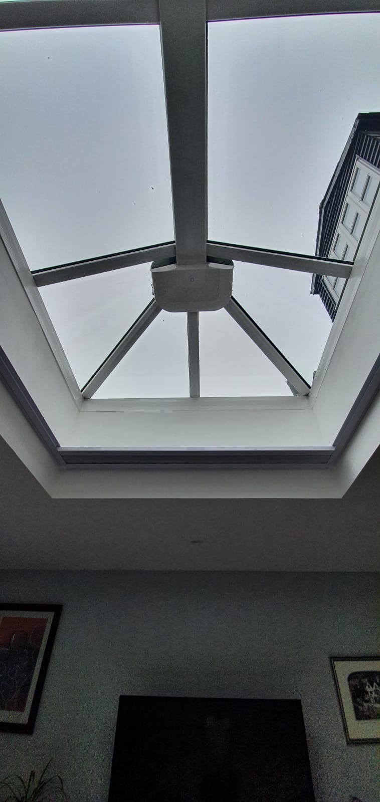 A living room with a skylight in the ceiling.