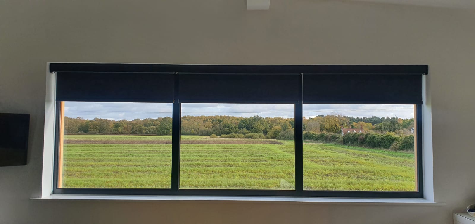 There is a large window with a view of a field.