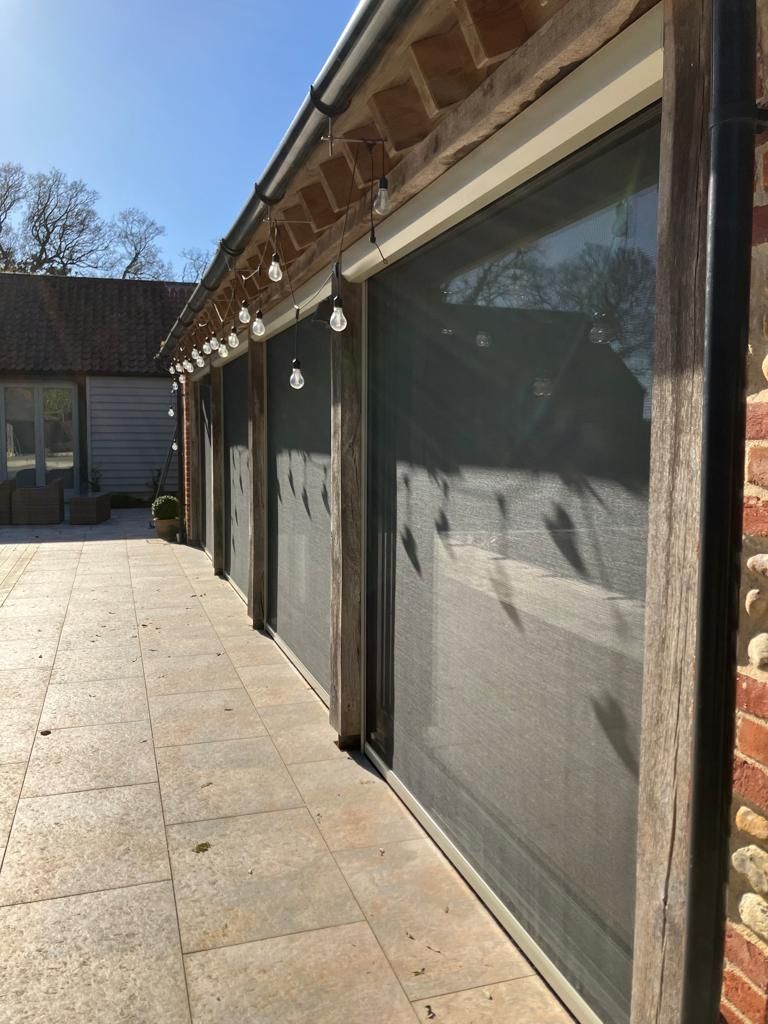 A row of sliding glass doors on the side of a building.