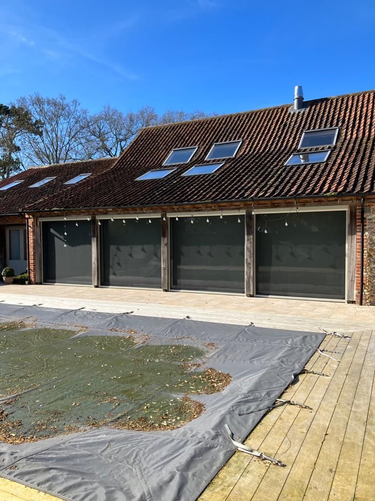 A large house with a swimming pool in front of it.