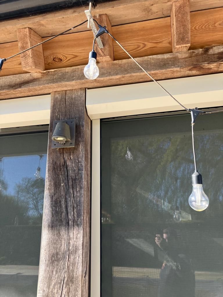 A string of lights hanging from the ceiling of a building.