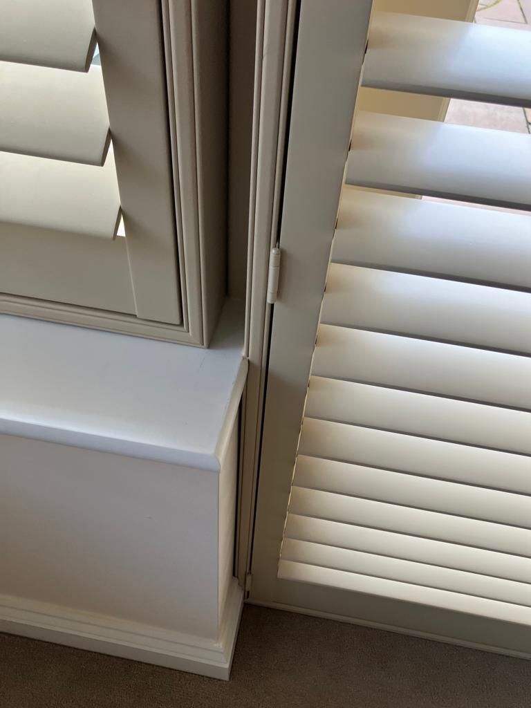 A close up of a window with shutters on it