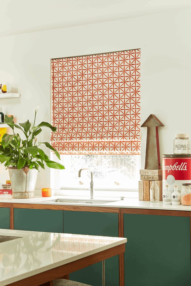 A kitchen with a sink , table , and window.