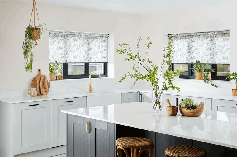 A kitchen with a large island and a sink.