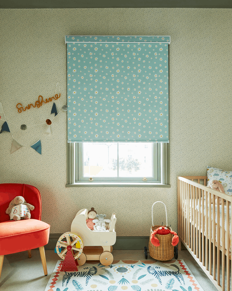 A child 's room with a crib , chair , and window.