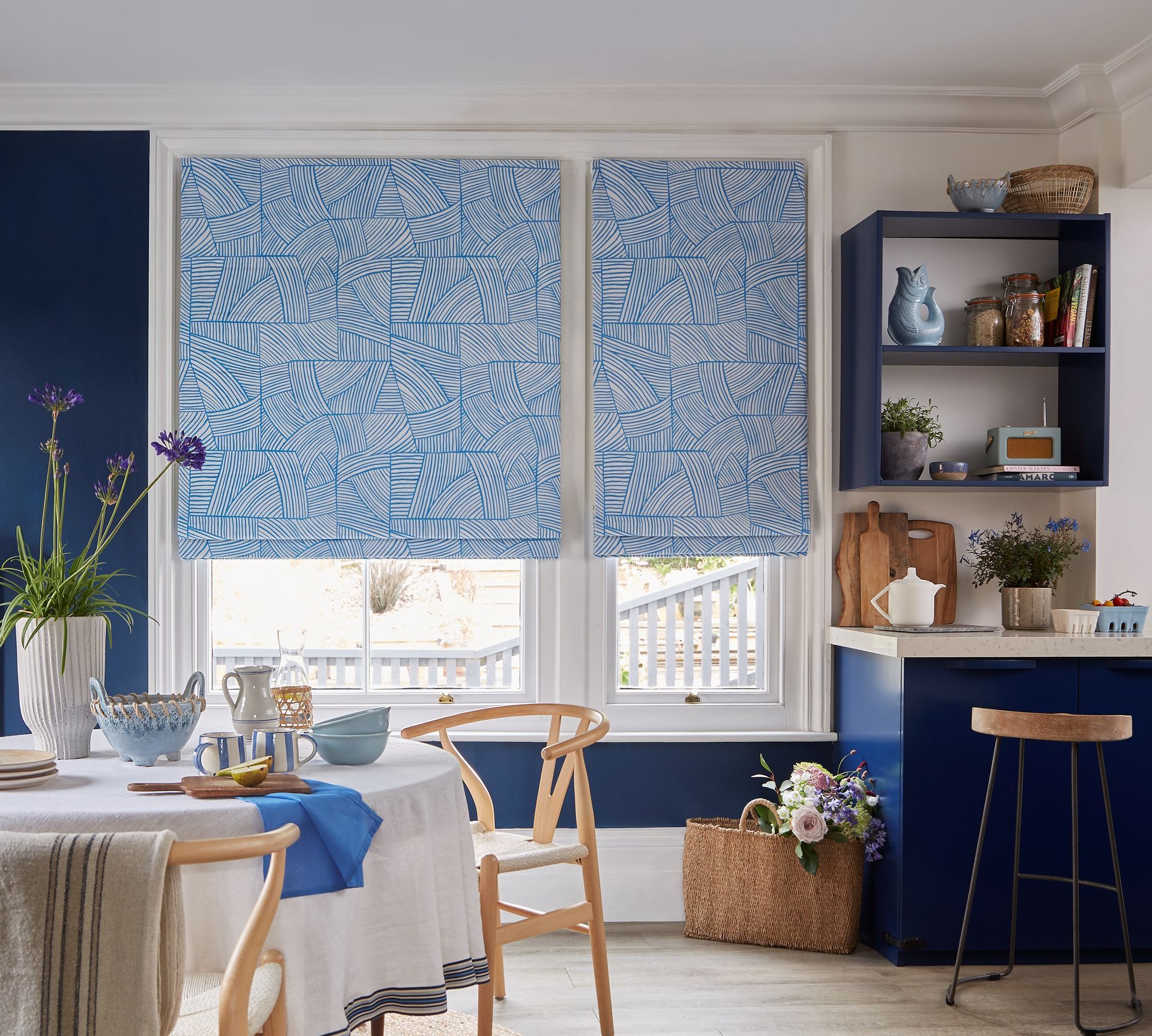 A woman is opening a sliding glass door with a mosquito screen.