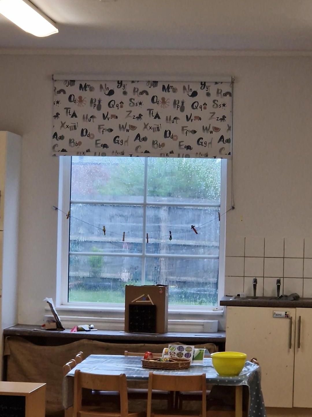 A kitchen with a table and chairs and a window