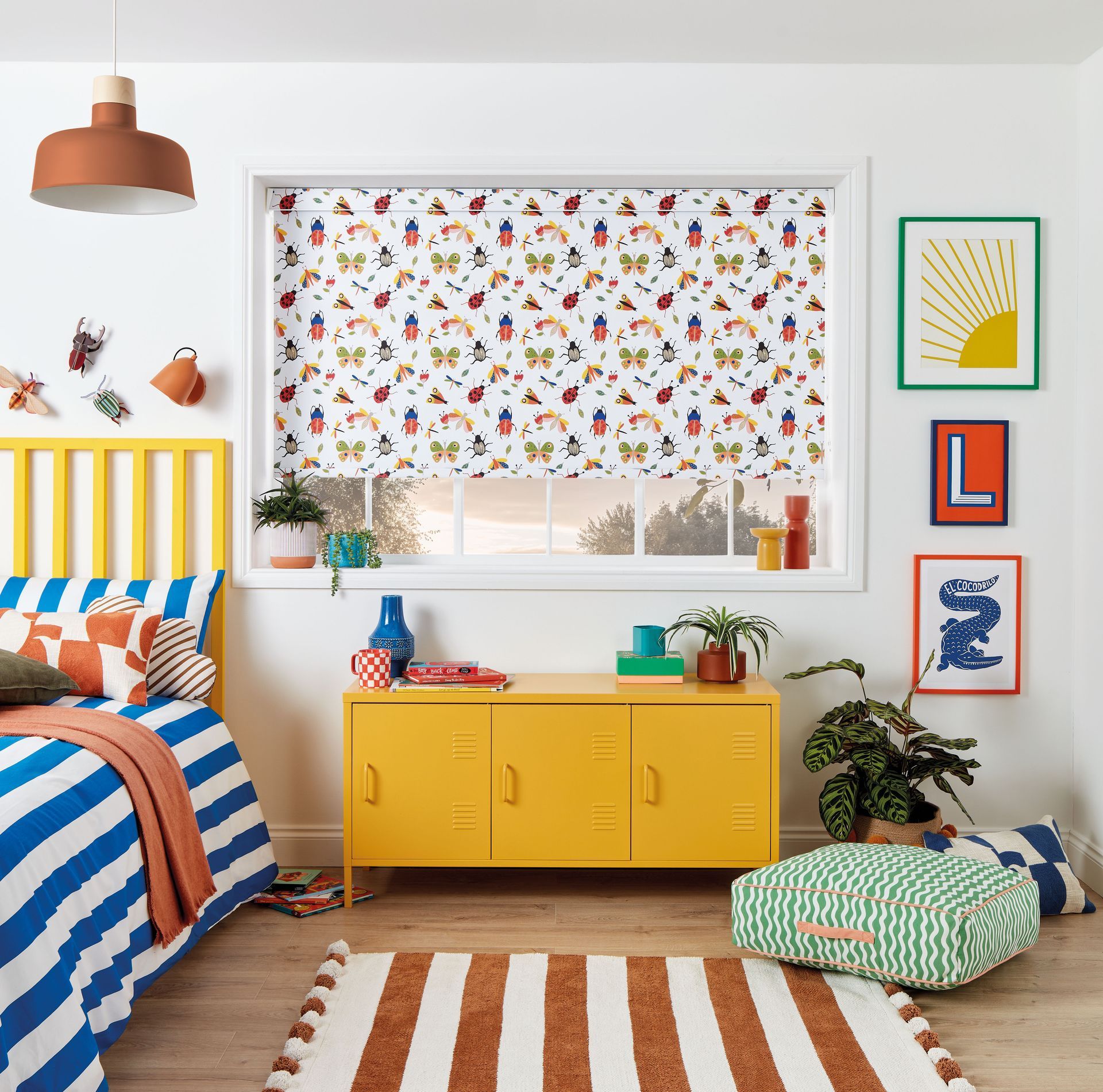 A bedroom with a bed , dresser , rug and window.